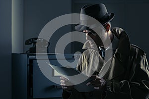 Undercover spy stealing files photo