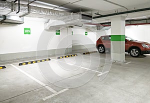 Underground car parking, empty modern parking lot indoor