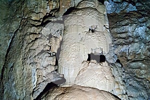 Underground cave with many stalactites and stalagmites of different shapes, speleology