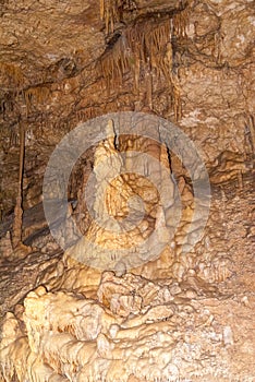 underground cave with many stalactites and stalagmites of different shapes, speleology