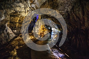 Underground creepy tunnel in dark cave or limestone grotto, speleology nature corridor in Adygeya mountains