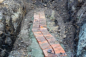 An underground electrical cable was opened to eliminate a cable break and again prepared for backfilling