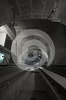 Underground facility with a big tunnel leading deep down. Metro - subway construction site