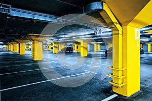 Underground garage parking lot with few cars and empty spaces