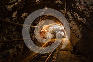 Underground gold mine passage with rails