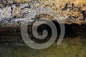 Underground lake sorrunded by rocks photo