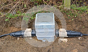 Underground link box with armoured cable connectors.