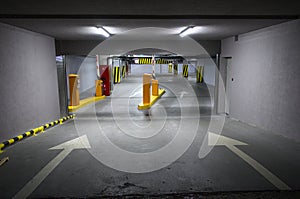 Underground parking with arrows and one parked car