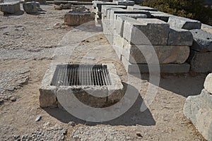 Underground reservoirs and ancient stone building blocks are located on the territory of the Acropolis of Lindos. photo