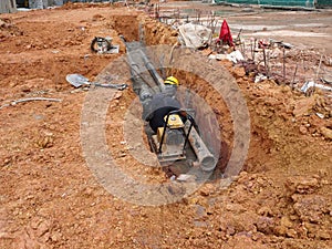 Underground sewerage pipe installed by construction workers at the construction site.