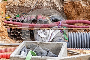 Underground utility supply lines and pipes laid underground and paved in trenches at construction site. PVC Pipe