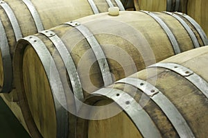 Underground wine cellar with rows of wooden barrels 6 photo
