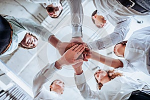 Underneath view, Business teamwork groups people hands, stacked huddle together, unity international