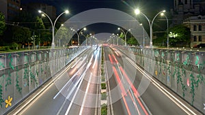 Underpass car traffic at night, with cars driving through an inner city tunnel called Pasajul Unirii, a landmark in Bucharest