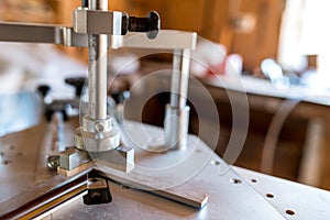 Underpinner on focus, picture framer tool in a small workshop