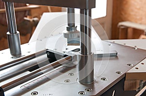 Underpinner in focus, picture framing tool.