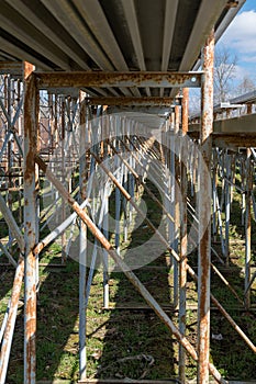 Underside of bleachers showcasing the beams, supports, and bracing elements that hold the bleachers together