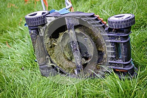 Underside of a Lawn Mower in long grass