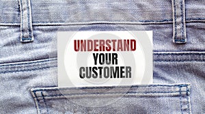 UNDERSTAND YOUR CUSTOMER words on a white paper stuck out from jeans pocket. Business concept