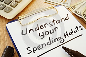 Understand your spending habits written on the clipboard. photo