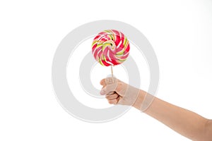 Understanding role sugar young diets. Hand of kid child holds colorful lollipop isolated white background. Children have