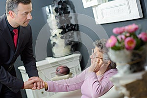 Undertaker comforting elderly woman