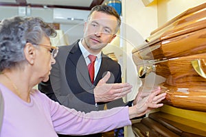 Undertaker showing woman coffin