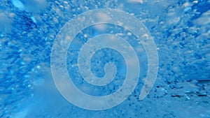 Underwater abstract shot of diving in swimming pool with lots of air bubbles. Beautiful under water background or