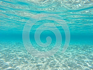 Underwater blue ocean background with sandy sea bottom