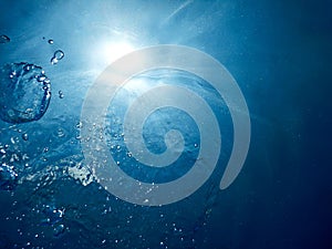 Underwater bubbles sunlight through water surface. Underwater ba