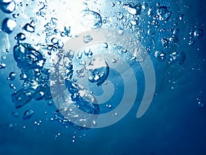 Underwater bubbles sunlight through water surface. Underwater ba