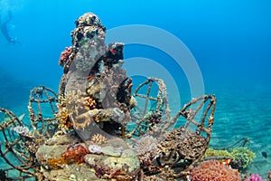 Underwater Buddha statue with diving snorkeler on the background