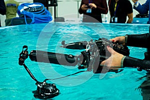 Underwater camera. Diver holds a camera for filming underwater