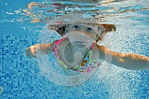 Underwater child jumps to swimming pool