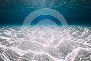 Underwater clear ocean background with sandy sea bottom