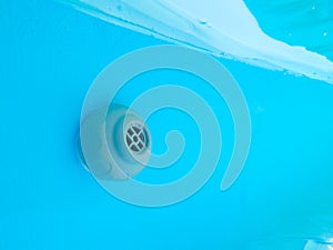 Underwater Close up of a grey pool plastic filter
