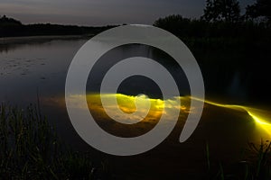 Underwater diving at night with flashlight. Light from river bottom. Full moon over foggy river Stohid. Moon light at night