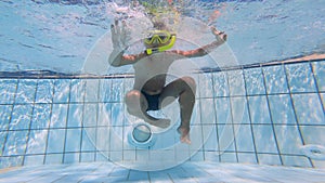 Underwater filming of a child diving into the pool
