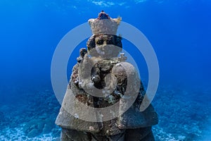 Underwater grotto of the holy child Jesus in a shallow coral reef