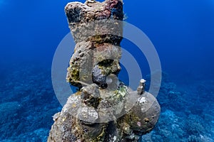 Underwater grotto of the holy child Jesus in a shallow coral reef photo