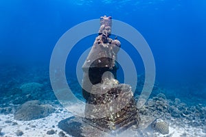 Underwater grotto of the holy child Jesus in a shallow coral reef