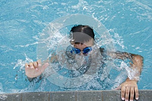 Underwater little boy in swimming pool with goggles