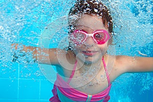 Underwater little girl blue swimming pool