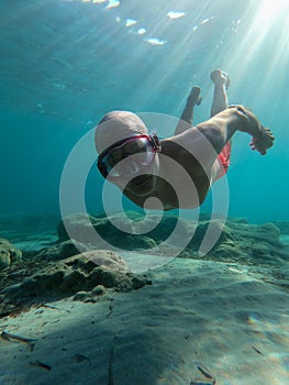 underwater man snorkeling in the sea withcrystal-clear waters concept of holiday relax summer beach diver in the sea