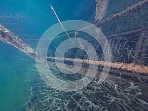 Underwater photo, flooded rusty stairs leading to the bottom, rummu quarry