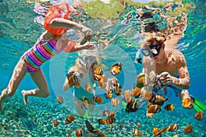 Underwater photo. Happy family snorkelling in tropical sea