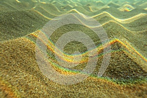 Underwater photo - light refracted on sea surface forming rainbows on small sand 