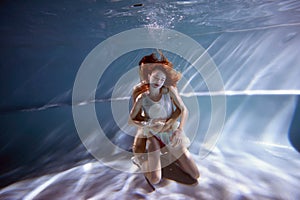 Underwater in the pool with the purest water. Loving couple hugging. The feeling of love and closeness. Soft focus