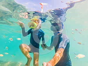 Underwater portrait of father and son snorkeling together