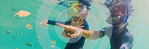 Underwater portrait of father and son snorkeling together BANNER, LONG FORMAT